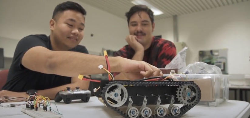 Student building a robot within a classroom